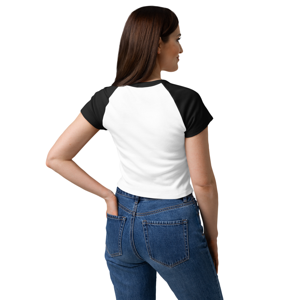 Woman modeling the back of a white and black raglan baby tee with black sleeves and a fitted silhouette.