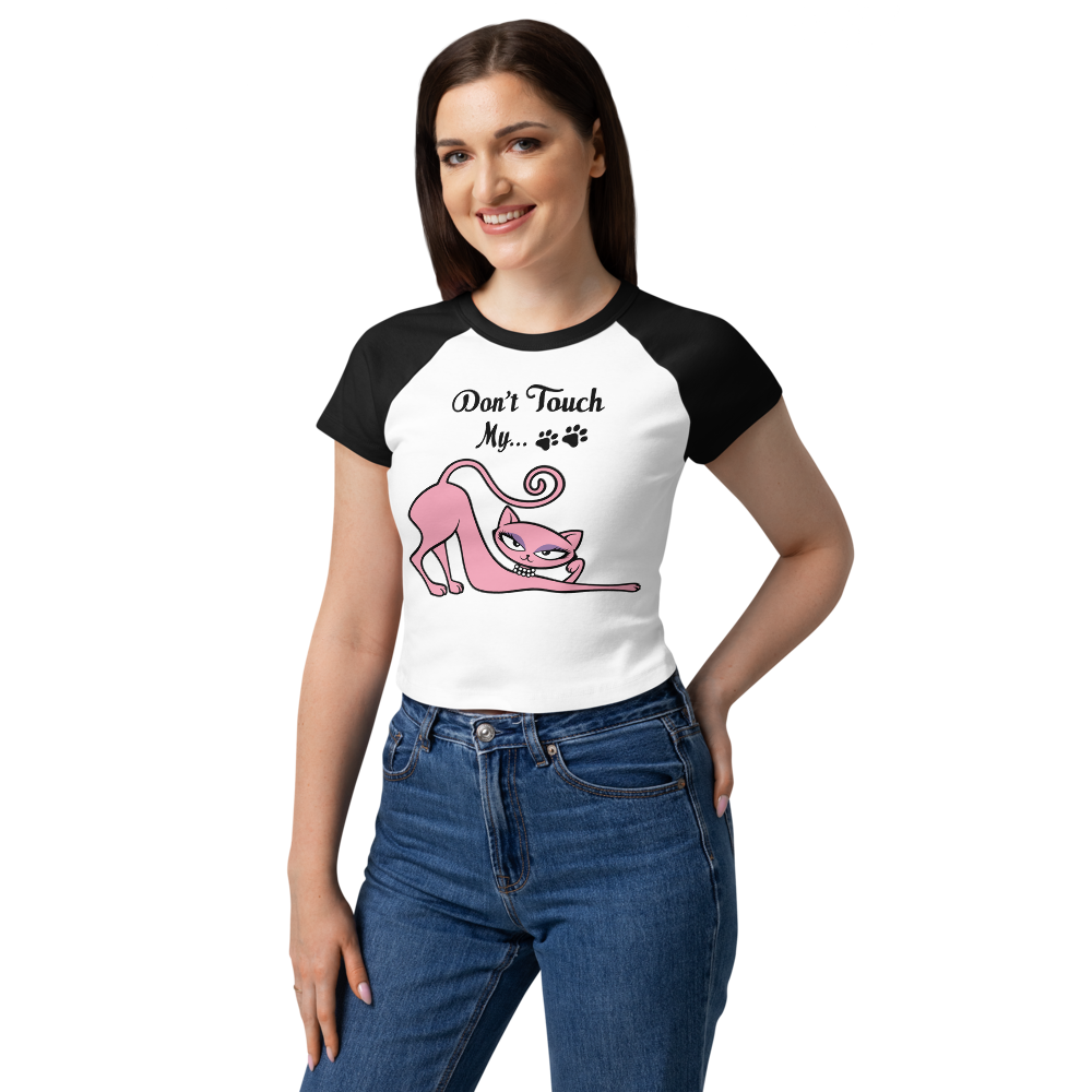 Model wearing a black and pink raglan baby tee featuring the Don't Touch My Kitty pink cat design.