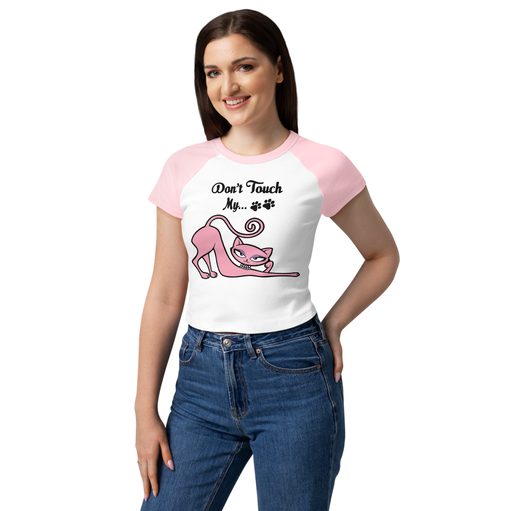 Model wearing a white and pink raglan baby tee featuring the Don't Touch My Kitty pink cat design.