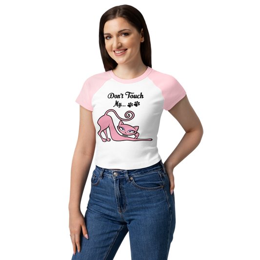 Model wearing a white and pink raglan baby tee featuring the Don't Touch My Kitty pink cat design.